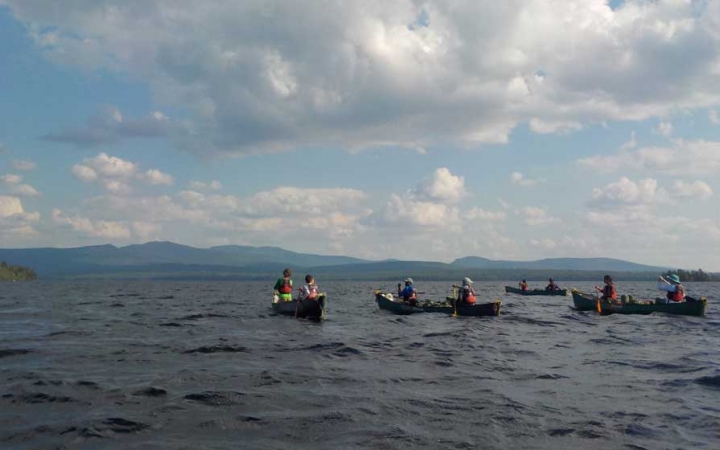 teens on group canoeing course